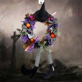 Couronne de porte Halloween - Décoration avec jambes de sorcière et accessoires festifs